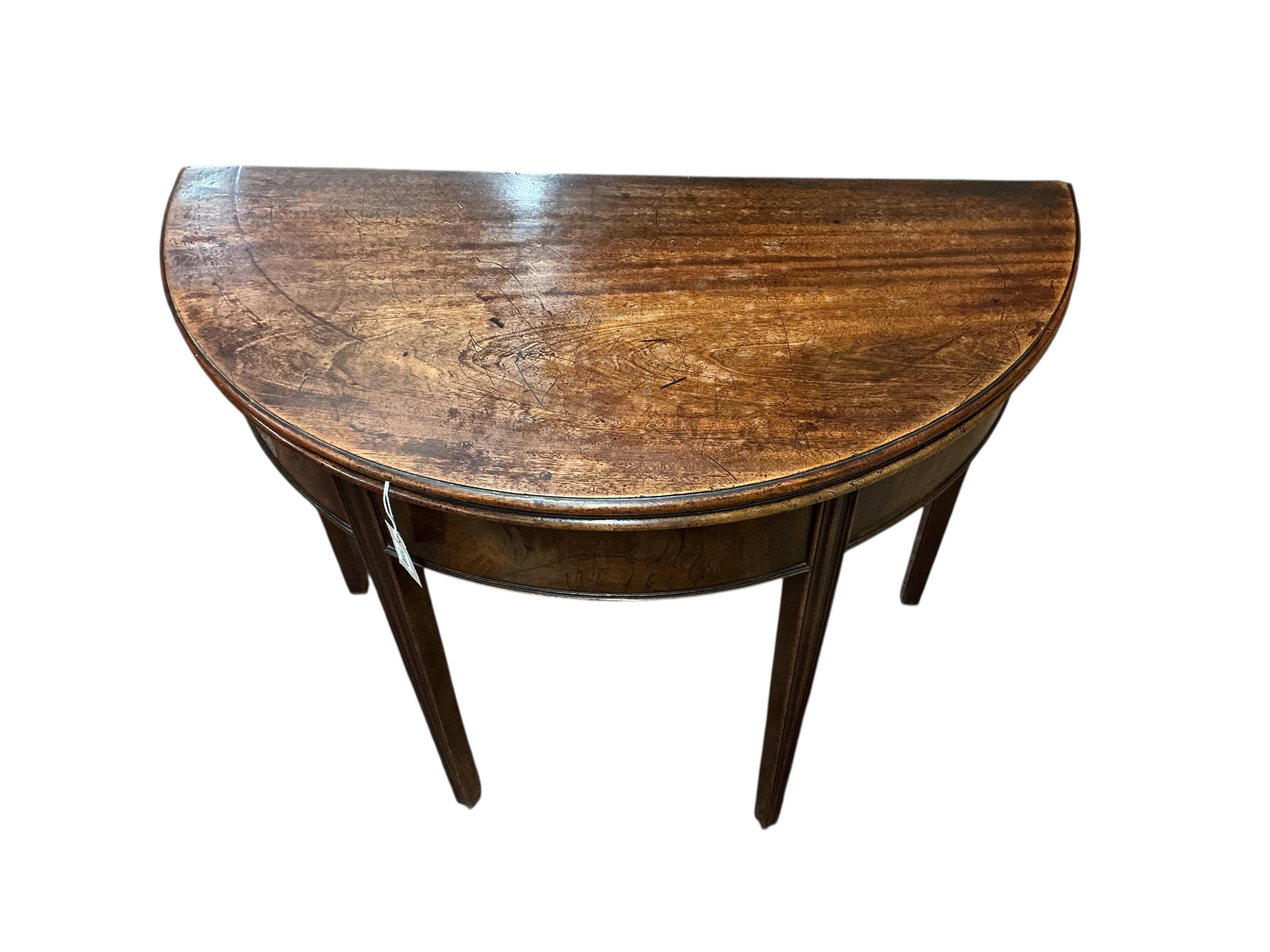 A George III mahogany demi lune folding tea table, width 93cm, depth 46cm, height 74cm